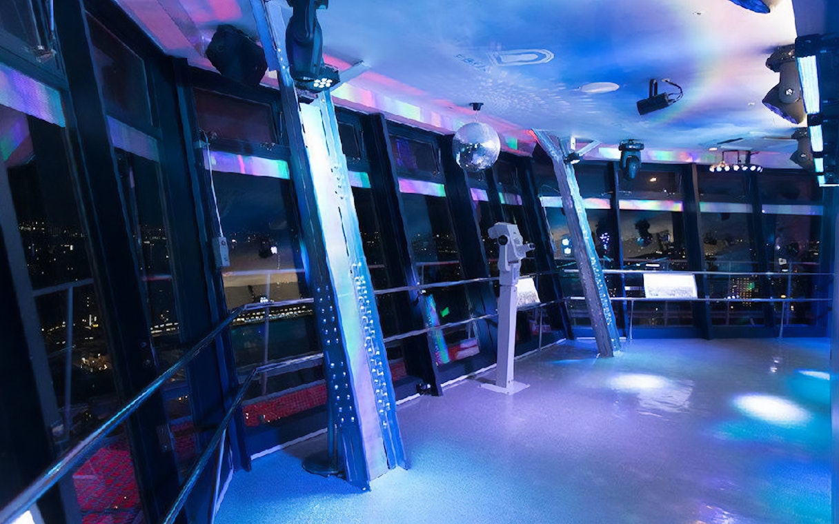 Observation deck inside Tsutenkaku Tower with city views at night.