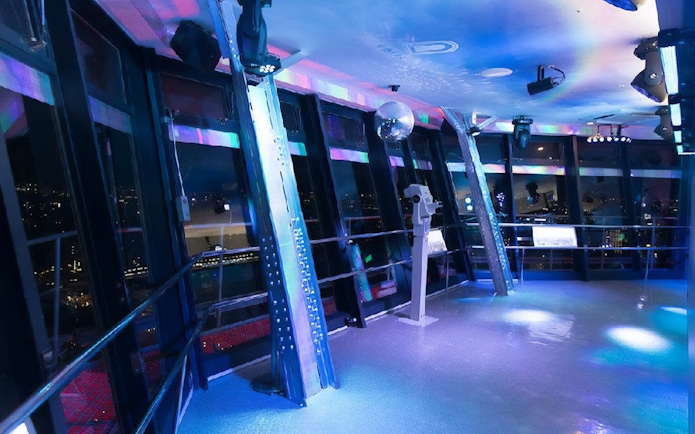 Observation deck inside Tsutenkaku Tower with city views at night.
