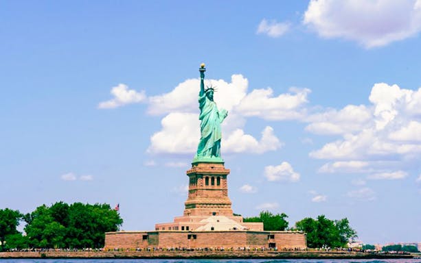 Statue of Liberty on Liberty Island with tourists, New York City.