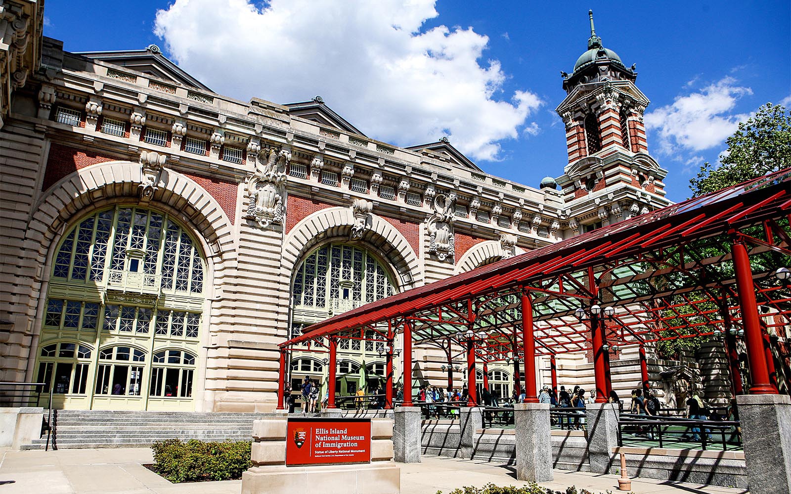Ellis Island National Museum of Immigration entrance with visitors, New York City.