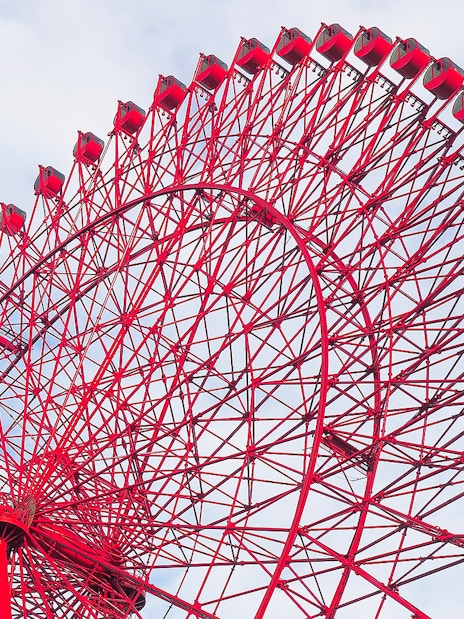 Red Ferris wheel against a blue sky, HEP Ferris Wheel Ticket.