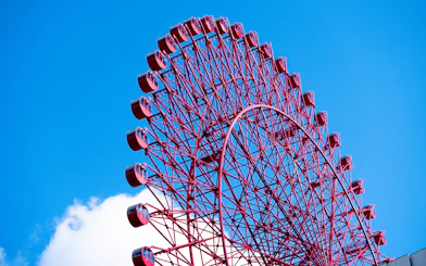 Red Ferris wheel against blue sky at HEP Five, Osaka.