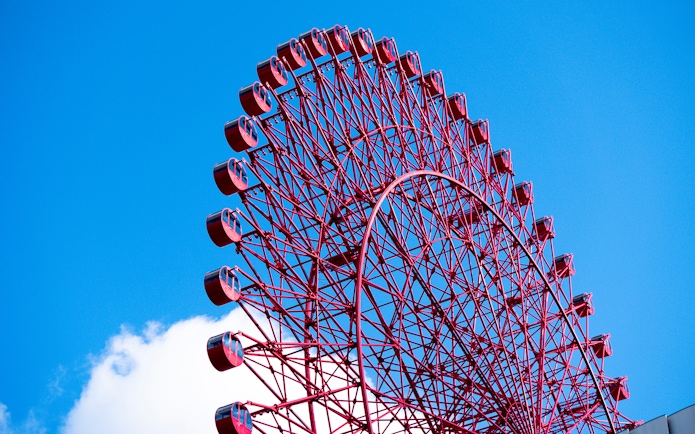 Red Ferris wheel against blue sky at HEP Five, Osaka.