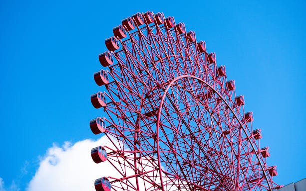 Red Ferris wheel against blue sky at HEP Five, Osaka.