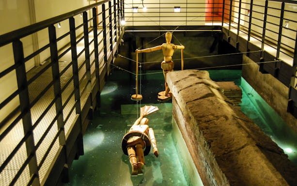Wooden mannequins in a water display at Rome's Leonardo da Vinci Museum.
