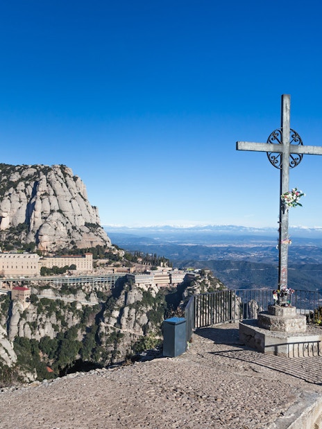 Cruz de San Miguel overlooking Montserrat Monastery and mountain landscape in Catalonia, Spain.
