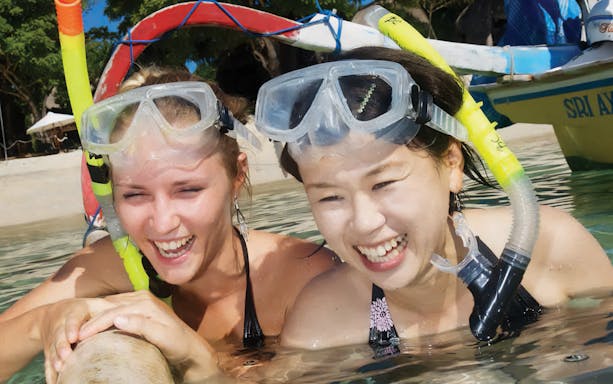 Snorkelers enjoying water activities on Nusa Lembongan Island cruise.