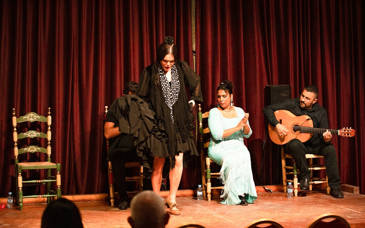 Flamenco dancer performing with musicians at Palau Dalmases, Barcelona.