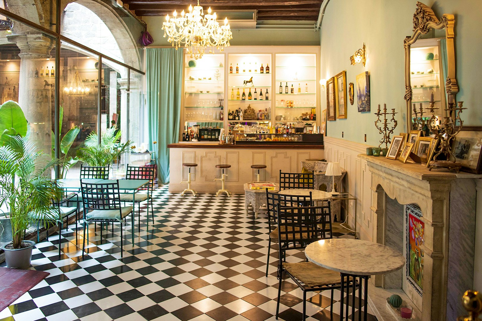 Palau Dalmases bar area with checkered floor and elegant decor, Barcelona.