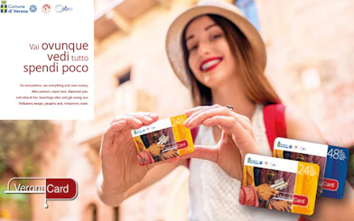 Woman holding Verona City Card with Gardaland Park offer.