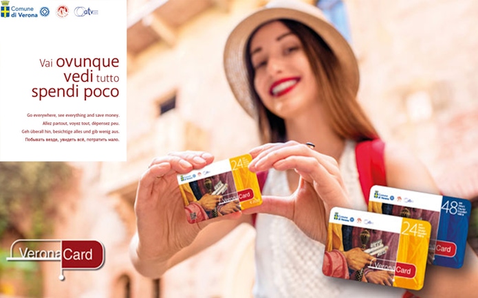 Woman holding Verona City Card with Gardaland Park offer.