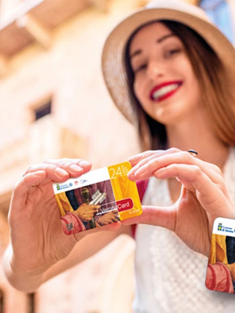 Woman holding Verona City Card with Gardaland Park offer.