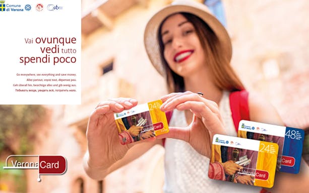 Woman holding Verona City Card with Gardaland Park offer.