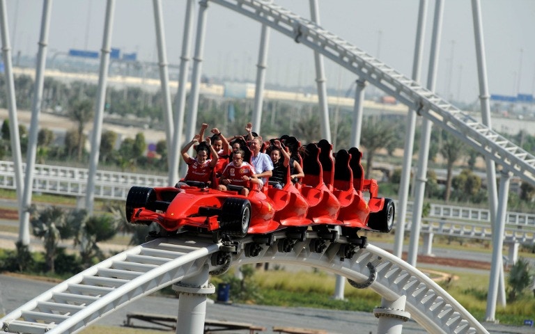 Roller coaster at Ferrari World Abu Dhabi with excited riders.