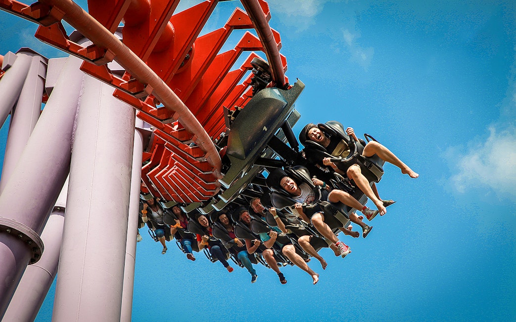Roller coaster ride at Siam Amazing Park, Bangkok, with people enjoying the thrill.