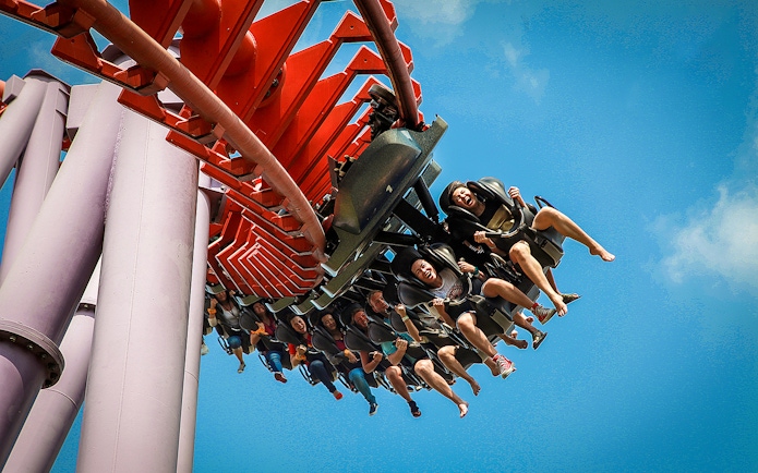 Roller coaster ride at Siam Amazing Park, Bangkok, with people enjoying the thrill.