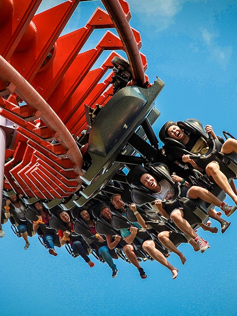 Roller coaster ride at Siam Amazing Park, Bangkok, with people enjoying the thrill.