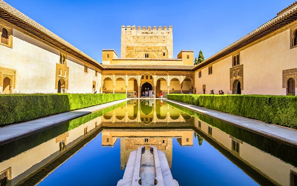 Alhambra's reflecting pool and Moorish architecture on a guided tour from Malaga.