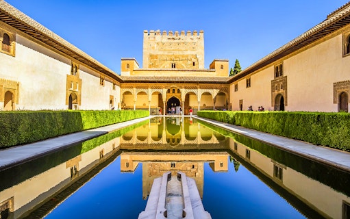 Alhambra's reflecting pool and Moorish architecture on guided tour from Seville.