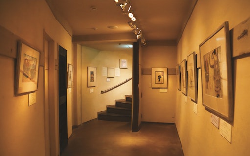 Kamigata Ukiyoe Museum interior with framed artworks lining the hallway walls.
