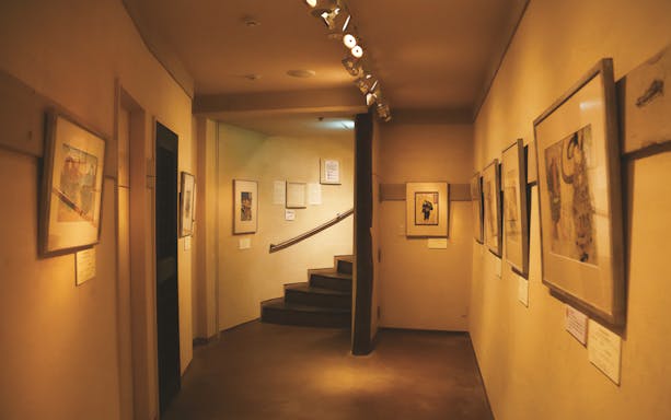 Kamigata Ukiyoe Museum interior with framed artworks lining the hallway walls.