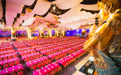 Phuket Fantasea theater with ornate decor and rows of red seats.