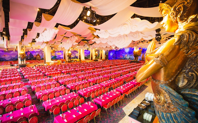 Phuket Fantasea theater with ornate decor and rows of red seats.