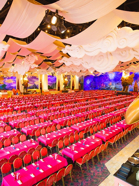 Phuket Fantasea theater with ornate decor and rows of red seats.