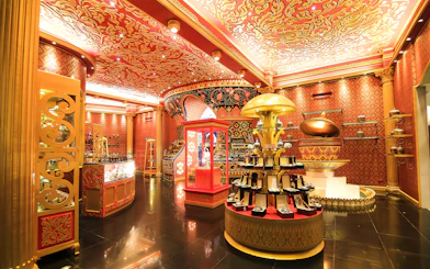 Phuket Fantasea ornate interior with vibrant red and gold decor, showcasing jewelry displays.
