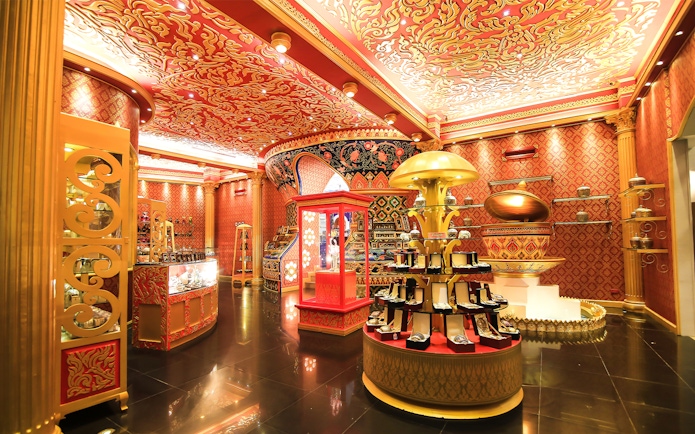 Phuket Fantasea ornate interior with vibrant red and gold decor, showcasing jewelry displays.