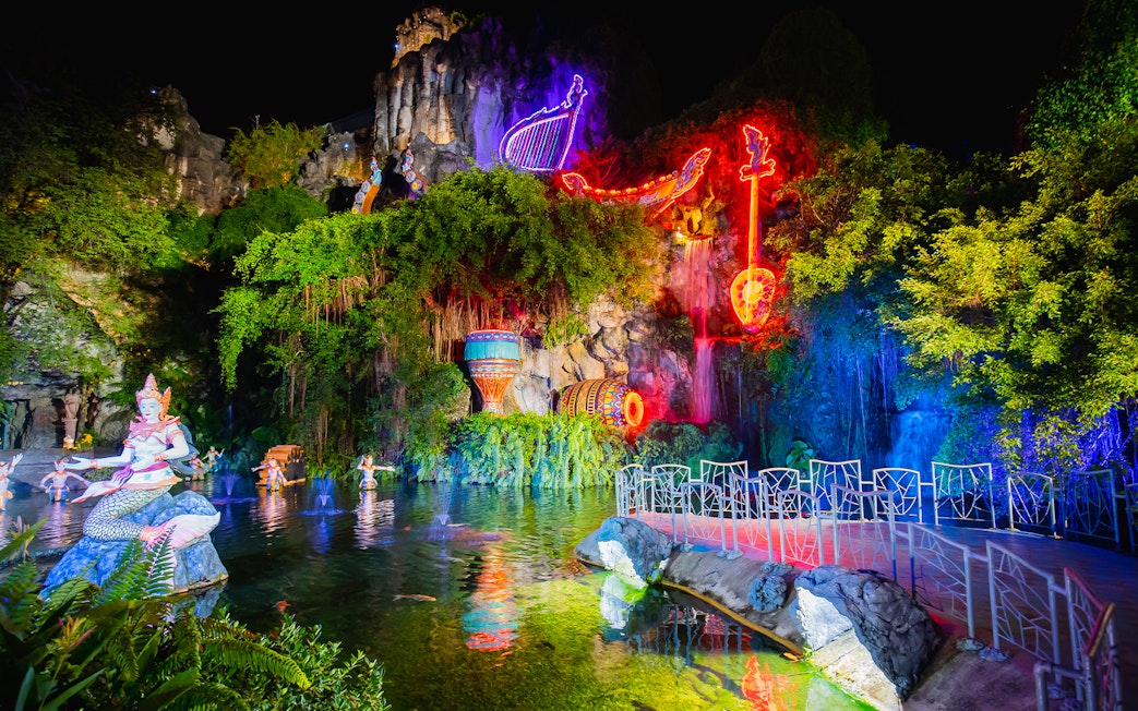 Phuket Fantasea neon-lit sculptures and water feature at night.