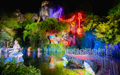Phuket Fantasea neon-lit sculptures and water feature at night.