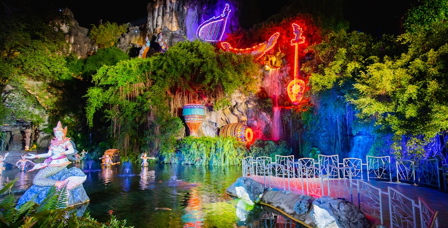 Phuket Fantasea neon-lit sculptures and water feature at night.