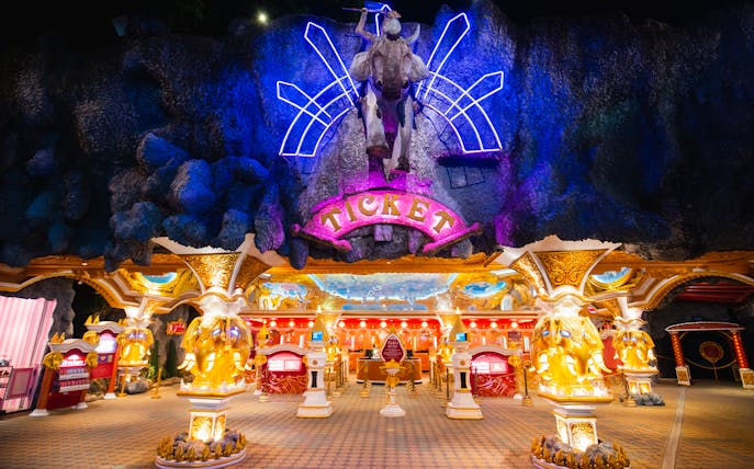 Phuket Fantasea entrance with neon lights and ticket booths.