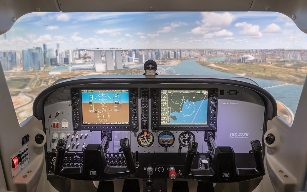 Cockpit view of flight simulator with Singapore skyline in background.
