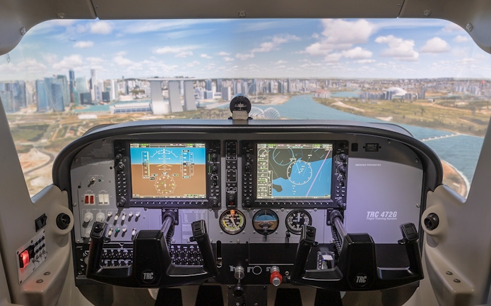 Cockpit view of flight simulator with Singapore skyline in background.