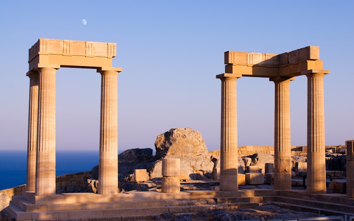 Ancient columns at Acropolis of Lindos with sea view, Rhodes, Greece.