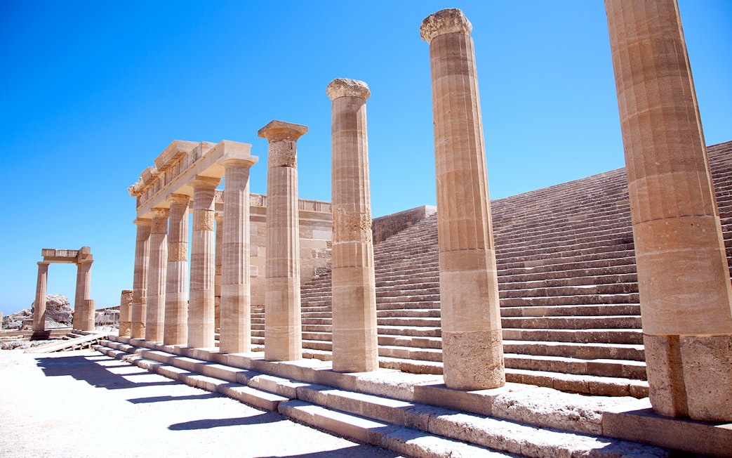Ancient columns and steps at the Acropolis of Lindos in Greece.