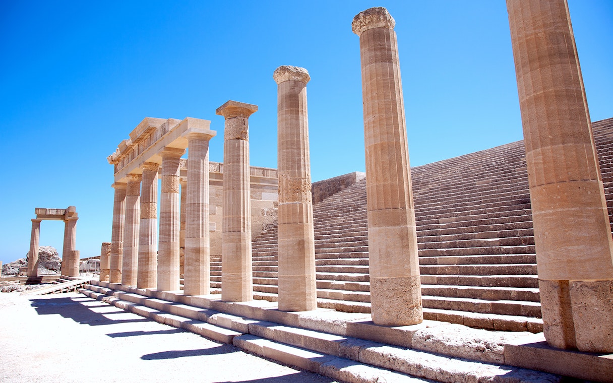 Ancient columns and steps at the Acropolis of Lindos in Greece.