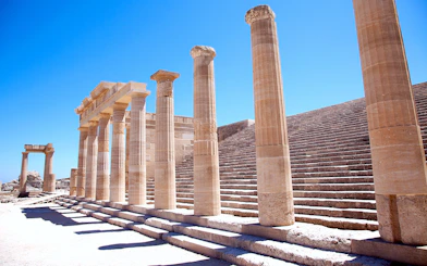 Ancient columns and steps at the Acropolis of Lindos in Greece.