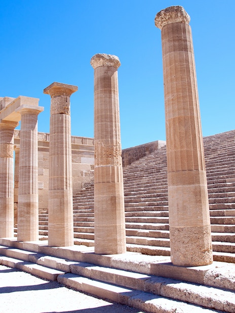 Ancient columns and steps at the Acropolis of Lindos in Greece.