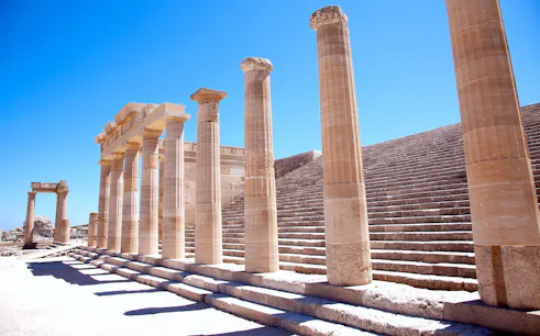 Ancient columns and steps at the Acropolis of Lindos in Greece.