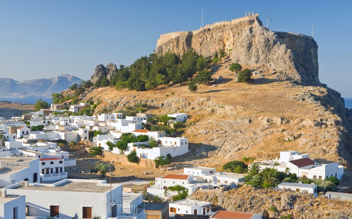 Acropolis of Lindos on a hilltop with white houses below, Rhodes, Greece.