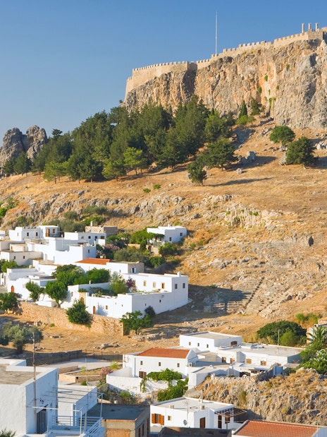 Acropolis of Lindos on a hilltop with white houses below, Rhodes, Greece.