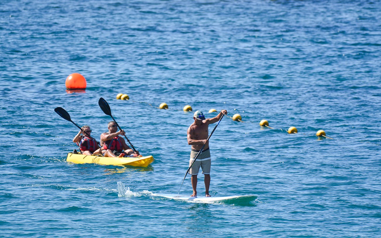 Kayakers and paddleboarder on Cabo San Lucas Glass Bottom Kayak Tour.