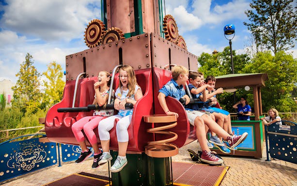 Children enjoying a ride at Cinecittà World theme park.
