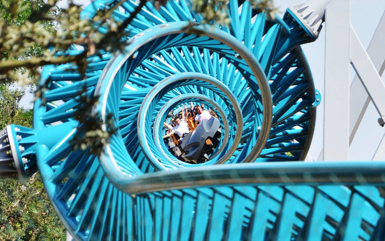 Roller coaster loop with riders at Cinecittà World, Italy.