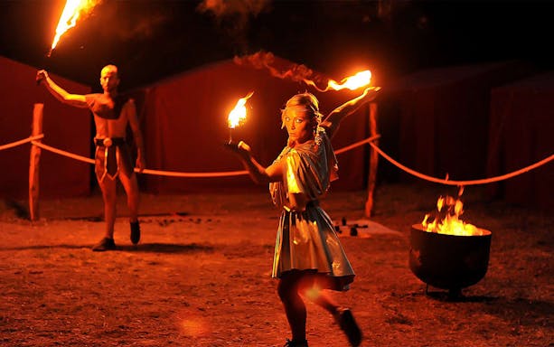 Fire performers at night show in Roma World, Italy.