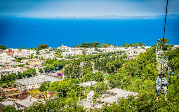 Chairlift view over Capri town and coastline, part of Capri & Anacapri tour from Sorrento.