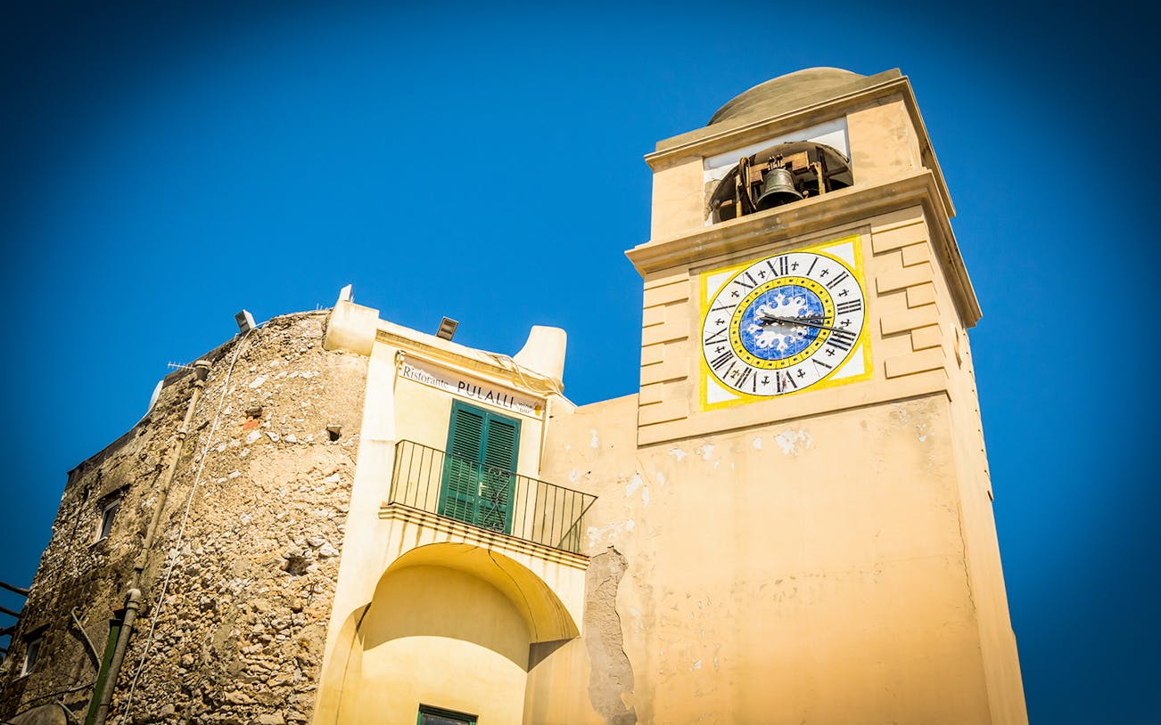 Capri clock tower with bell, viewed during Capri & Anacapri tour from Sorrento.